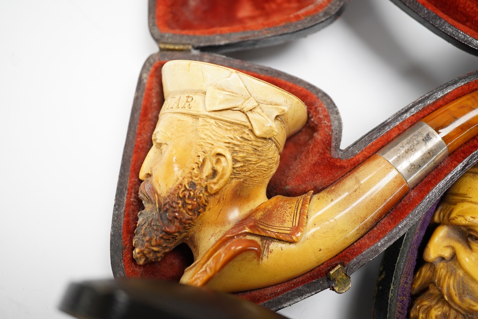 Three cased assorted Meerschaum pipes; sailor, boy on a pole and a Turk, largest Turk 19cm long. Condition - all pipes have damage either in pipe bowls or amber, cases worn